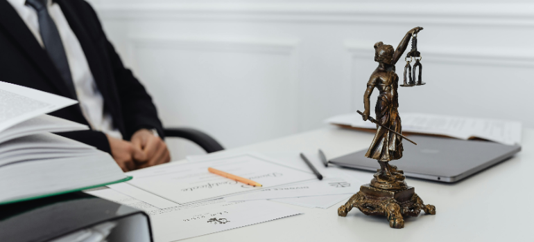 a man behind his desk thinking how can he keep balancing work and addiction recovery in PA