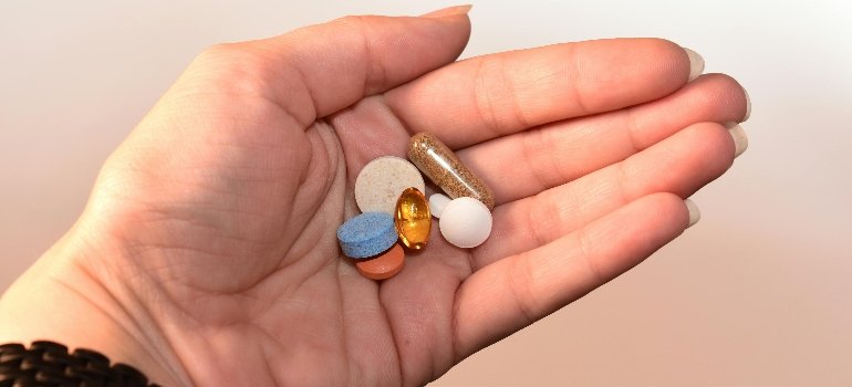 a person holding pills