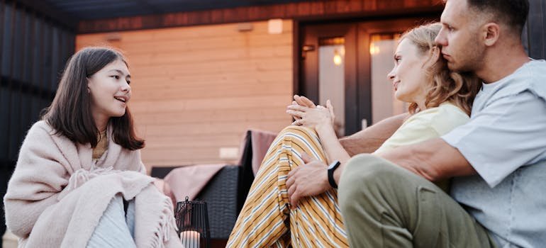 a girl having a conversation with her parents