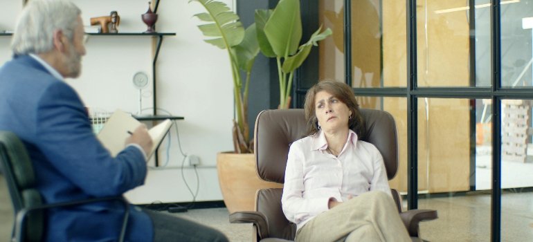 A woman talking to a male therapist