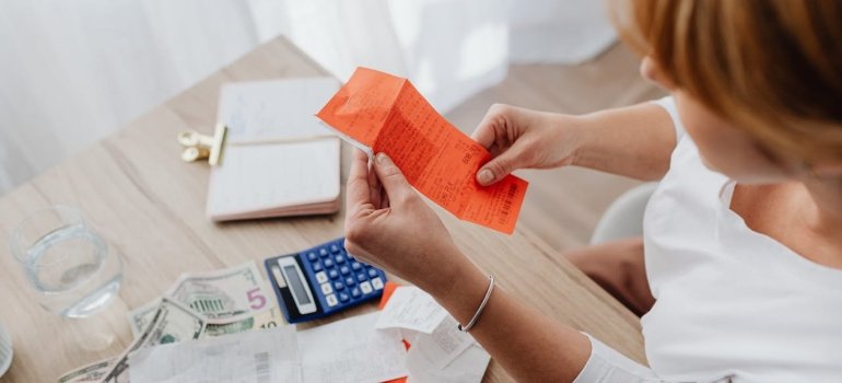 a woman holding a receipt for rapid detox in her hand
