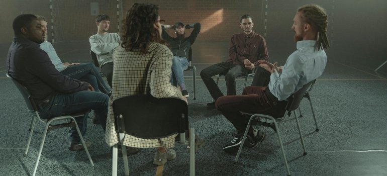 People in group therapy talking about how to overcome prescription drug addiction