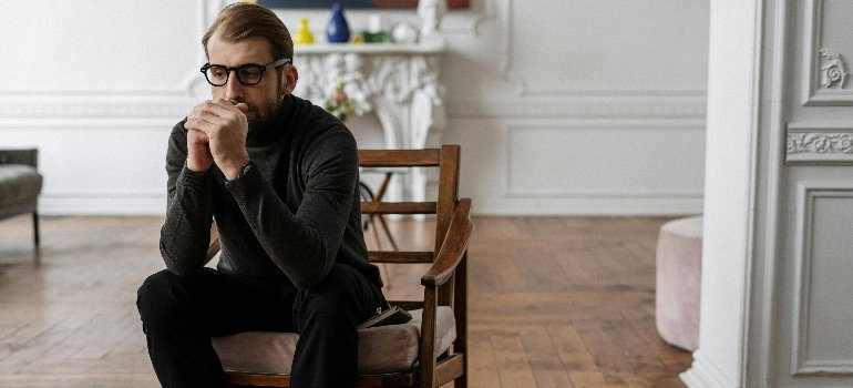 a man sitting on a chair in distress