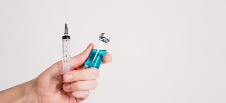 Syringe and a bottle of methadone.