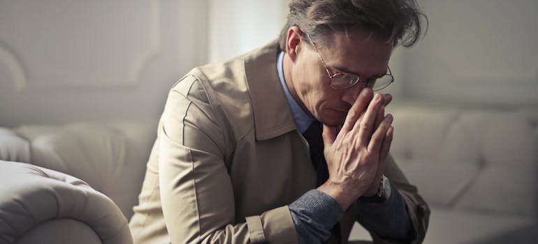 a worried man thinking about the signs of heroin use