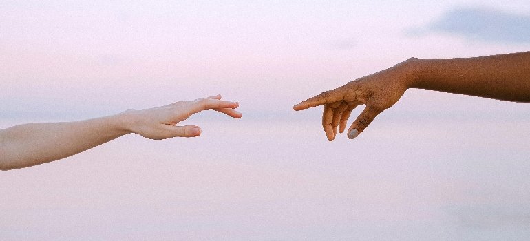 People Reaching Each Other's Hands