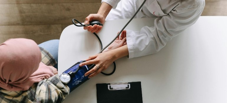 A Doctor Taking Patient's Blood Pressure