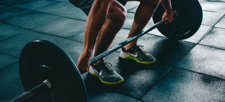 a person lifting weights wondering how not to gain weight after quitting drugs