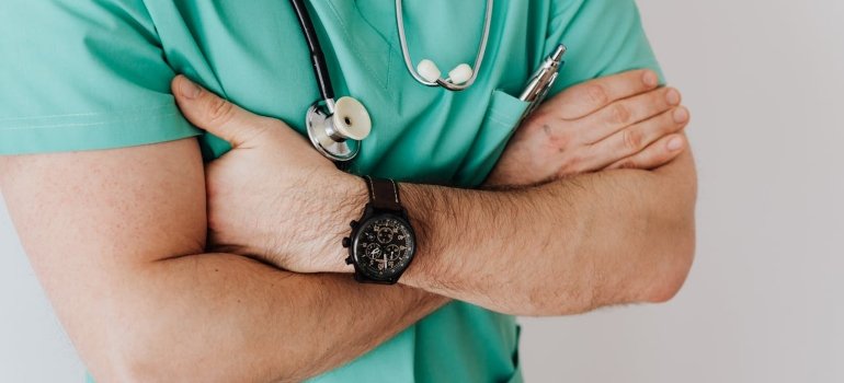 a doctor with arms crossed thinking about the link between Adderall and kidney failure