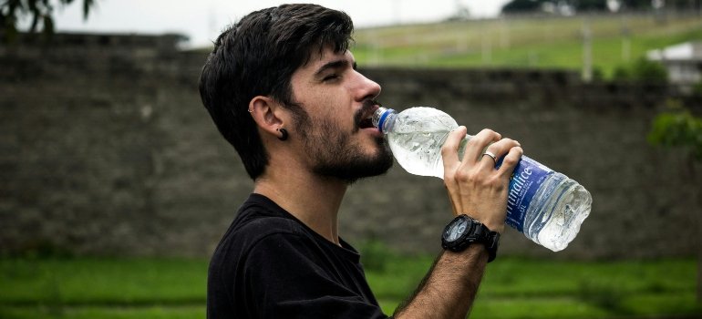 A man drinking water from a bottle