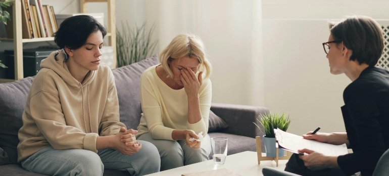 A mother and daughter talking to a therapist