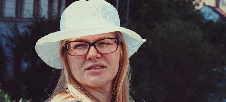 Woman squinting her eyes while looking at the sun.