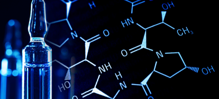 A glass test tube and, to the left, a drawing of chemical structures