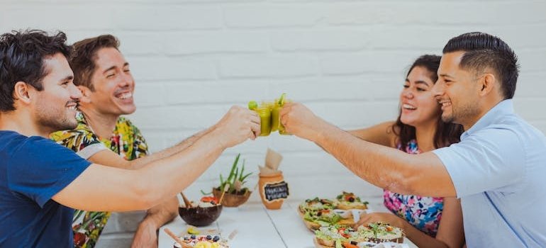 Friends drinking vegetable juice in a restaurant talking about the health benefits of going 30 days without alcohol