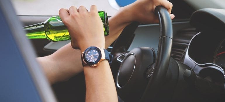 Man drinking beer while driving.