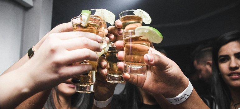 the 4 types of drinkers holding shots of tequila