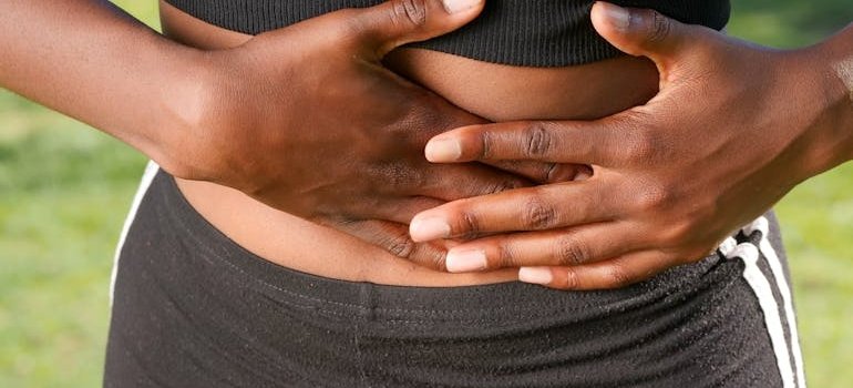 Woman holding her stomach.