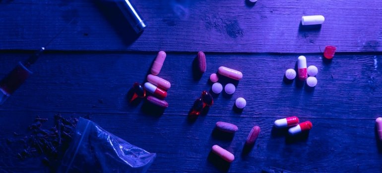 multiple drugs on a wooden table 