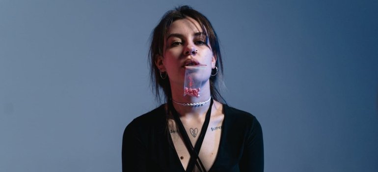 a woman holding a bag of pills in her mouth 