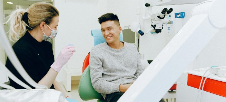 A dentist talking to a patient about the dental effects of methamphetamine use