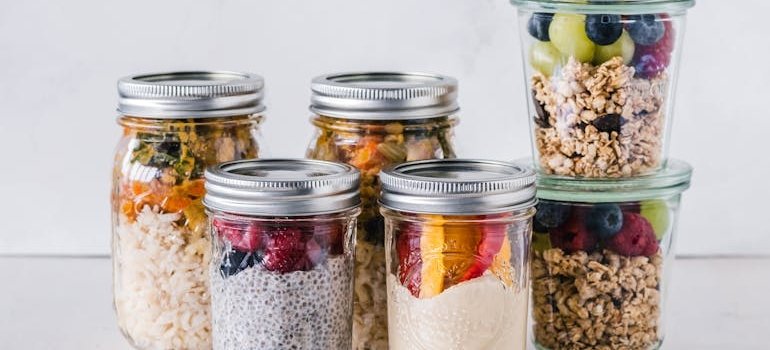 Mason jars filled with granola and Greek yoghurt.