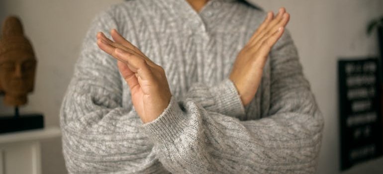 Woman holding her arms in front of her chest.