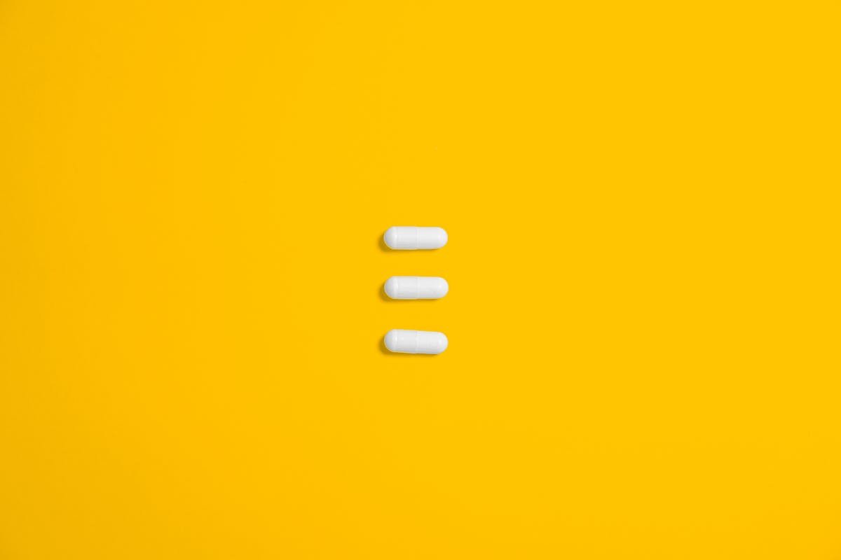 White Three Oval Capsule on Yellow Canvas