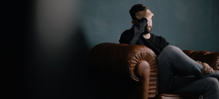 a man having a headache due to Soma addiction