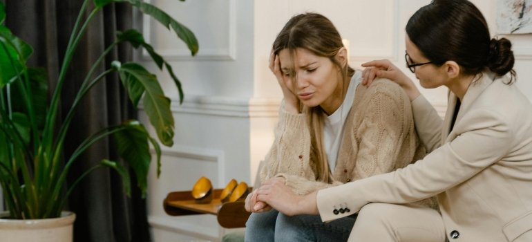 A woman is giving support to her pregnant friend, struggling with alcohol abuse.