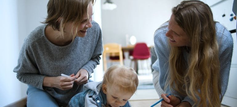 Two women taking care of a child.