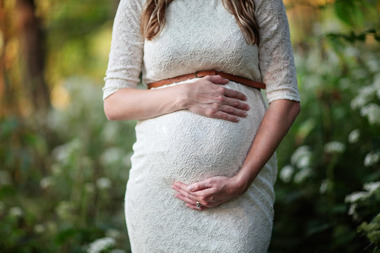 Pregnant woman holding her stomach.