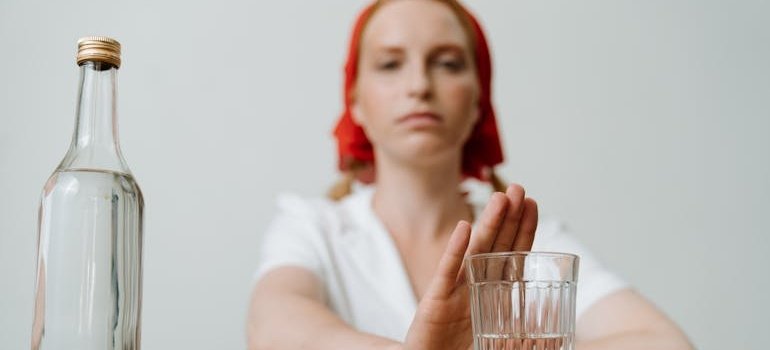 Woman refusing an alcoholic drink.