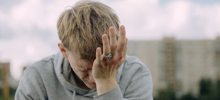 Man rubbing his eye with the palm of his hand.