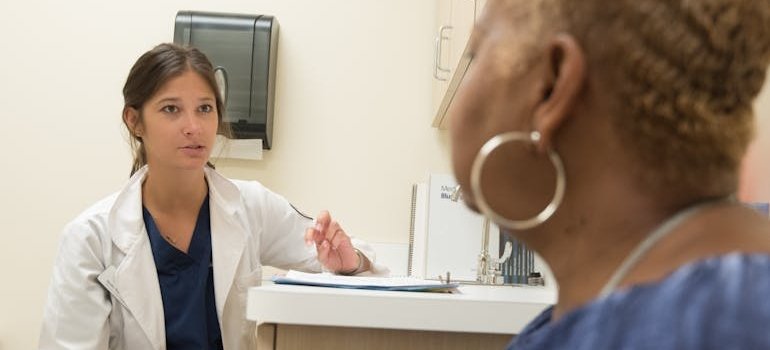 Woman talking to a doctor during her first week in rehab.