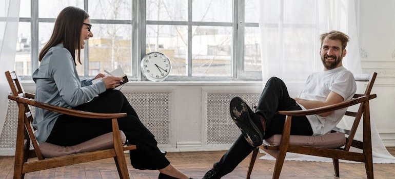 Woman laughing while talking to a man.