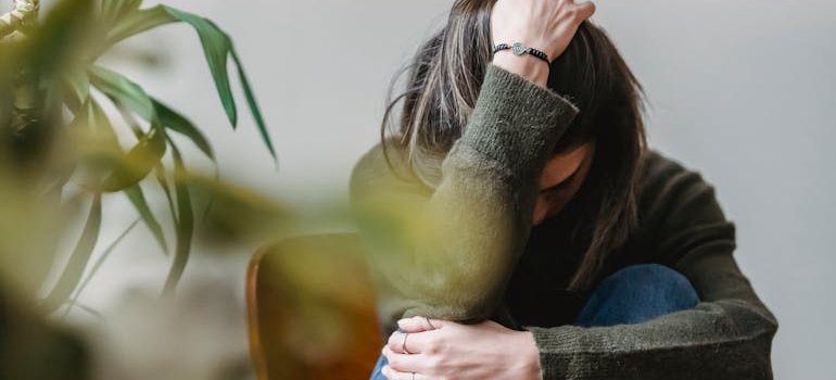 Woman sitting on a chair and holding her hair.