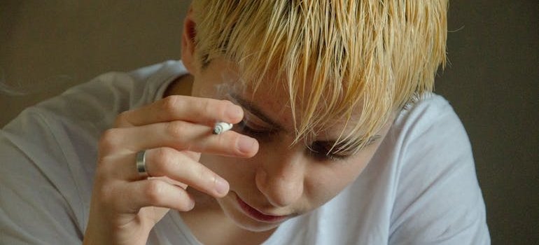 Man smoking a cigarette and worrying about setbacks in recovery.