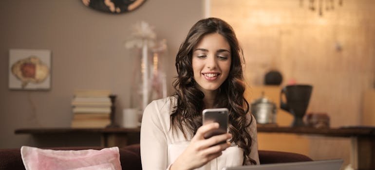 Woman searching for daily recovery readings and meditations on her phone.