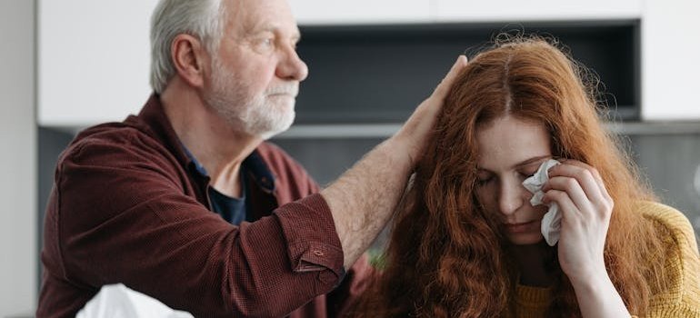 Father comforting his crying daughter.