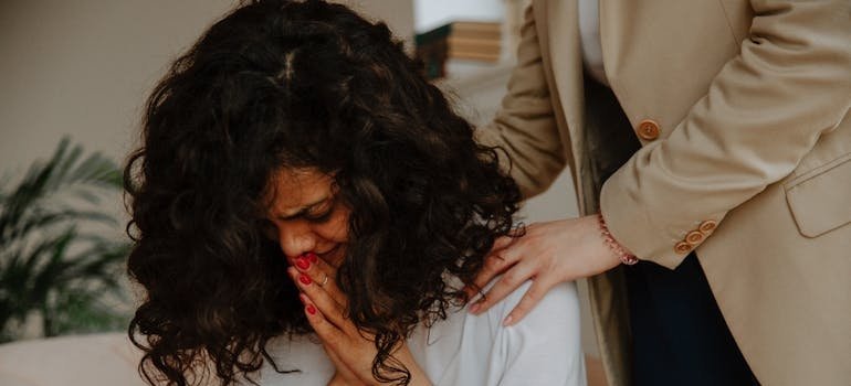 Mother comforting her crying daughter.
