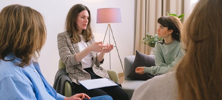 People in a support group talking about daily recovery readings and meditations.