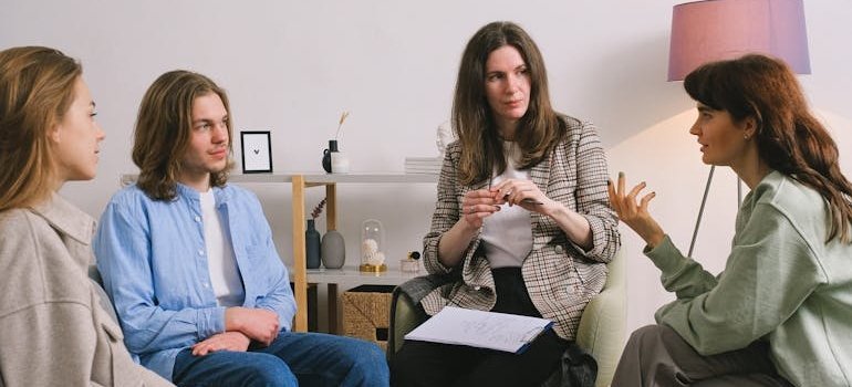 People in group therapy discussing alcoholic relapse after long term sobriety.