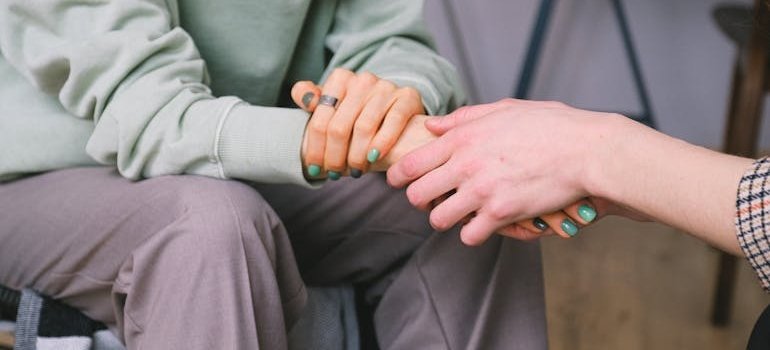 Person holding a woman's hand.