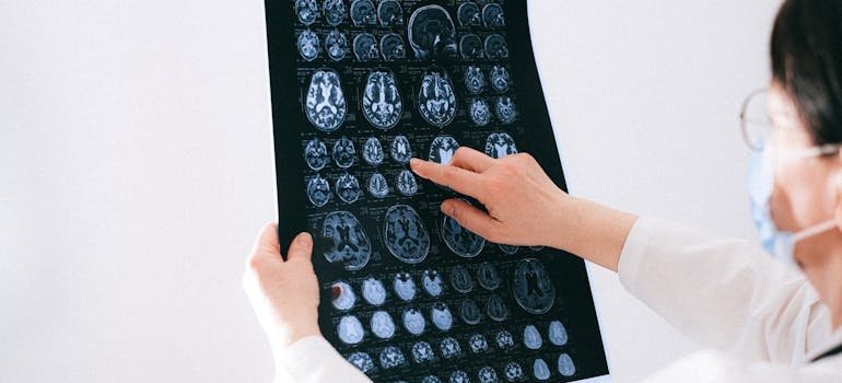 Doctor pointing to an MRI while talking about can meth cause mental illness.