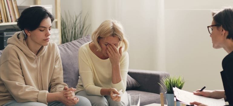 Woman and her teenage child talking to a therapist.