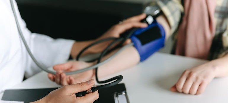 Person having their blood pressure checked by a doctor.