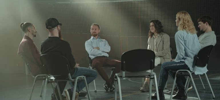 People discussing can meth cause mental illness in a support group.