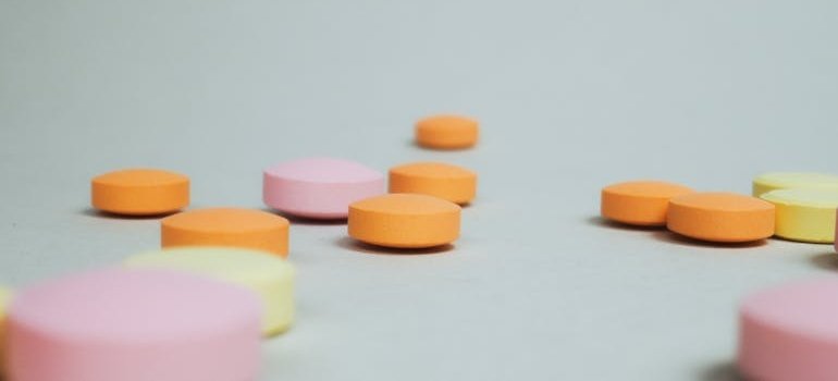 Colorful pills on a white floor.
