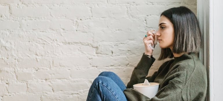 Woman crying and holding a box of tissues.