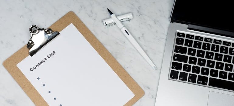 Contact list next to a laptop.